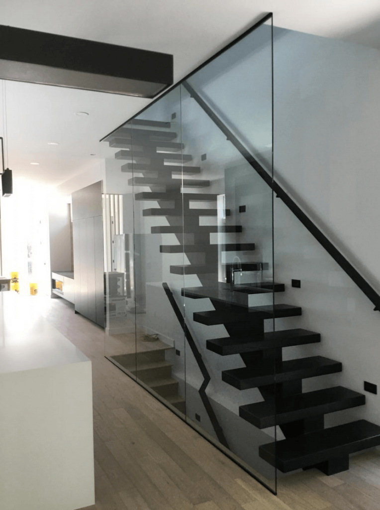 A beautiful staircase with a glass pane wall