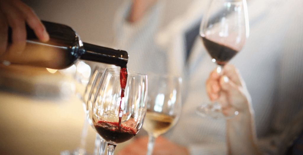 Wine being poured into a wine glass - What you need to know about Glass Wine rooms